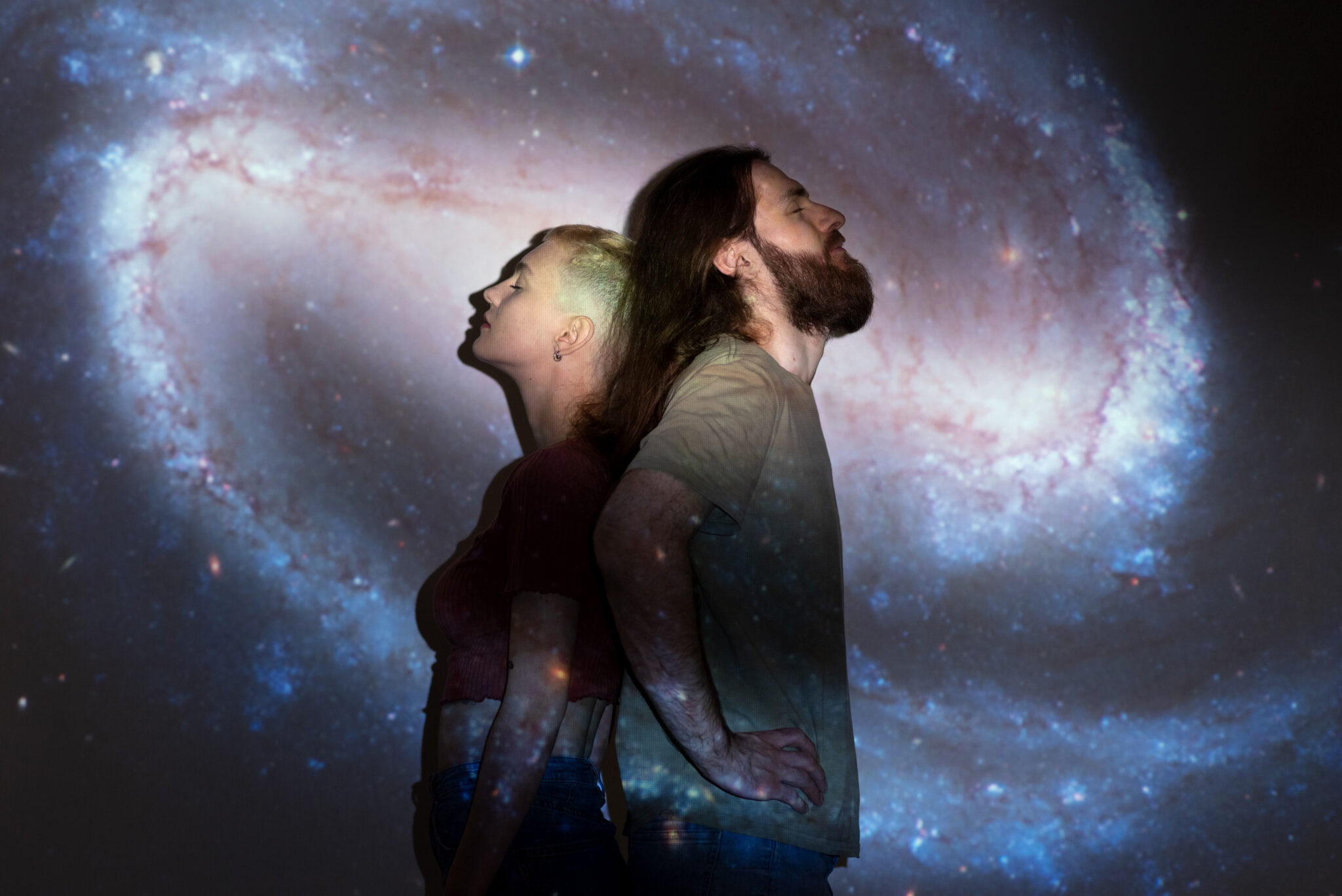 portrait-man-woman-posing-with-universe-projection-texture